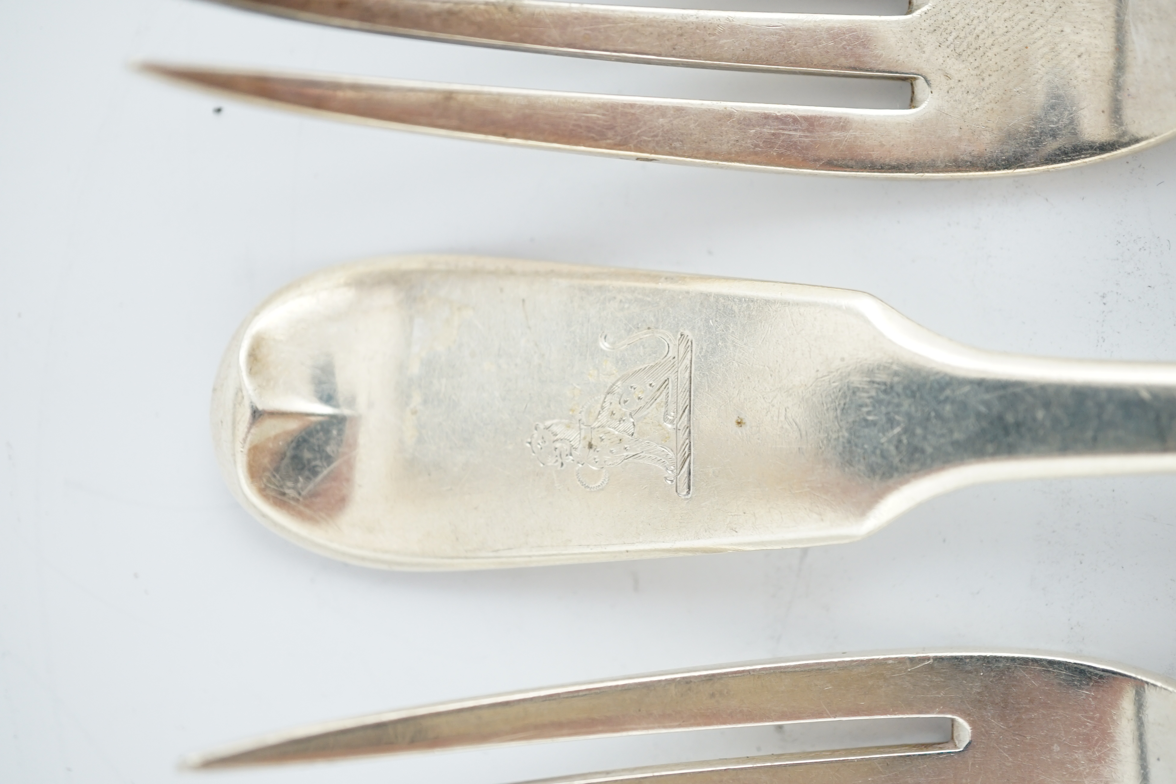 A set of seven George III silver Hanovarian pattern table forks, George Smith, London, 1776, 20.2cm, together with a set of six William IV Irish silver fiddle pattern table forks, Thomas Farnett, Dublin, 1831